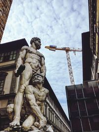 Low angle view of statue against building