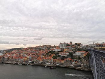 River amidst buildings in city against sky