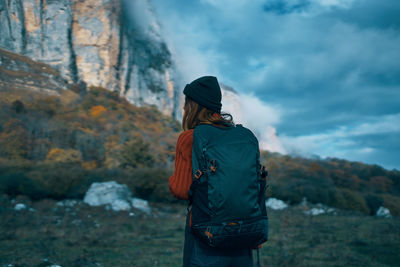 Rear view of man standing against mountain