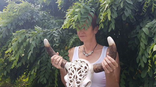 Midsection of woman standing by plants