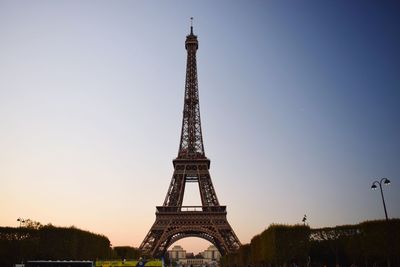 Communications tower in city against clear sky