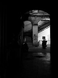 Silhouette street amidst buildings in city