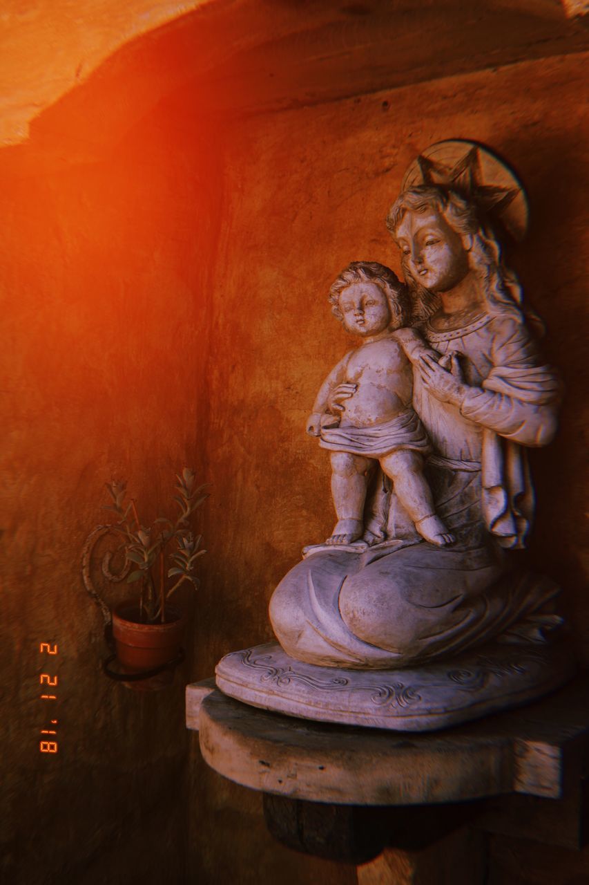 BUDDHA STATUE AGAINST BUILDING