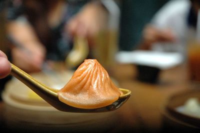 Close-up of soup dumpling or xiao long bao  in spoon on table