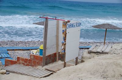 Lifeguard hut on beach against sky