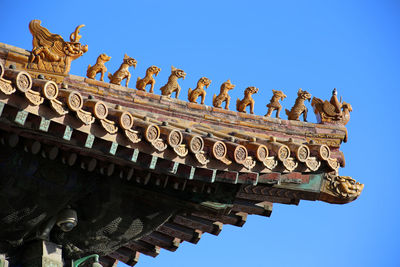 Low angle view of pagoda against clear blue sky