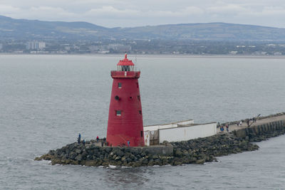 Lighthouse at the end of a harbour wall