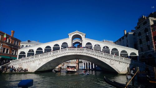 View of bridge over canal against blue sky