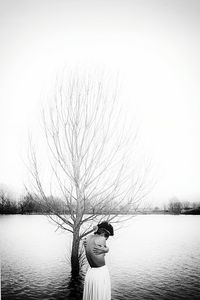 Woman standing by lake