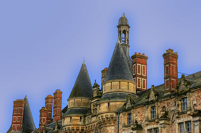 Low angle view of building against blue sky