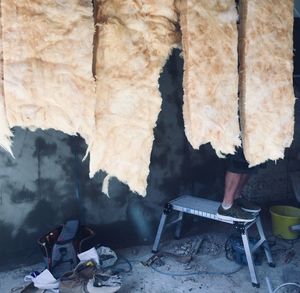 Man sitting on chair in abandoned room