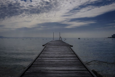 Pier over lake against sky