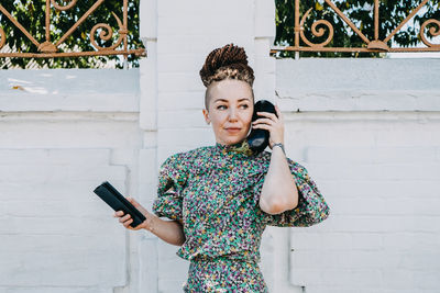 Portrait of young woman using mobile phone