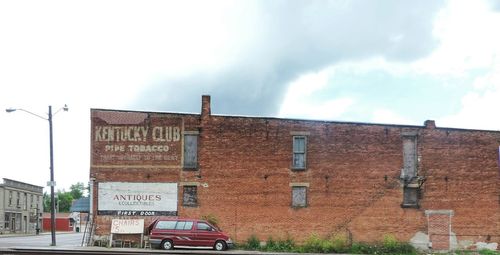 Low angle view of sign board against sky