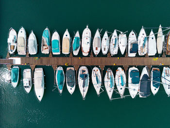 Row of boats moored in calm blue water