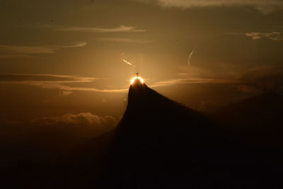 Silhouette mountain against sky during sunset