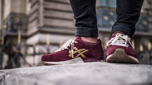 Low section of man wearing shoes standing outdoors