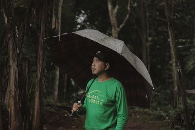 Full length of young man standing in rain