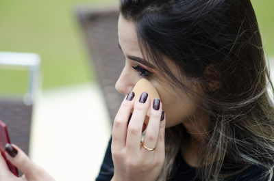 Close-up portrait of woman holding hands