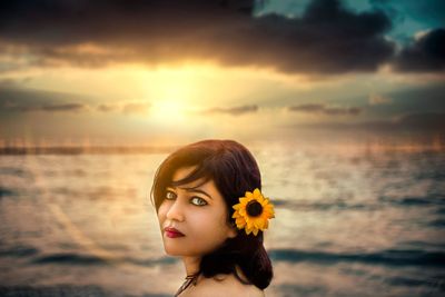 Portrait of woman against sea during sunset