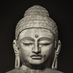 Close-up of statue against black background