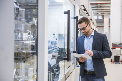 Man using tablet in factory shop floor