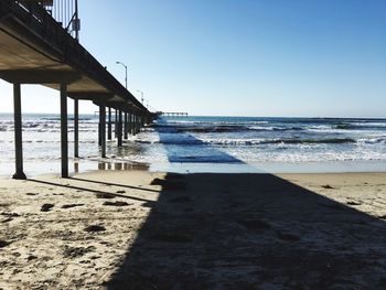 Scenic view of beach against clear blue sky