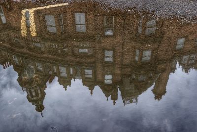 Reflection of buildings in puddle