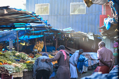 Rear view of people at market stall