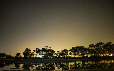 Scenic view of lake against sky at night