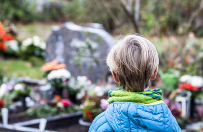 Close-up of boy in graveyard