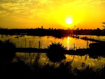 Scenic view of lake against orange sky