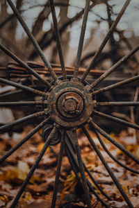 Close-up of rusty wheel on field