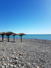 Scenic view of beach against clear blue sky