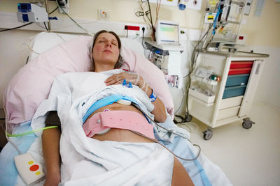 High angle view of doctor examining patient in hospital