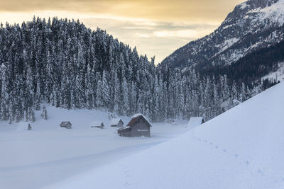 Snow covered landscape against sky