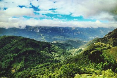 Scenic view of mountains against cloudy sky