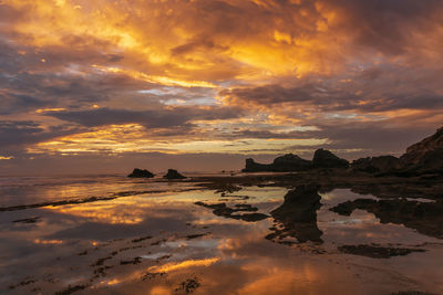 Scenic view of dramatic sky over sea during sunset