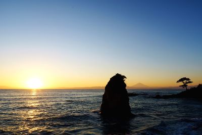 Scenic view of sea against clear sky during sunset