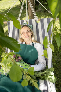 Portrait of smiling young woman sitting on table