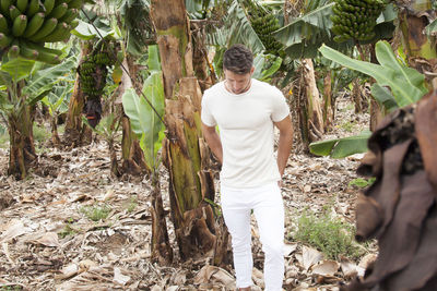 Man standing amidst trees