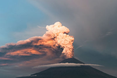 Smoke emitting from volcanic mountain against sky