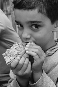 Close-up portrait of boy eating food