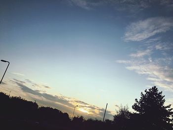 Low angle view of silhouette trees against sky during sunset