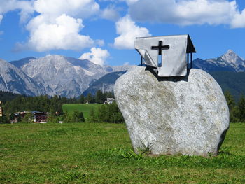 Built structure on field against mountain range