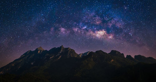 Night view of nature mountain with universe space of milky way galaxy and stars on sky