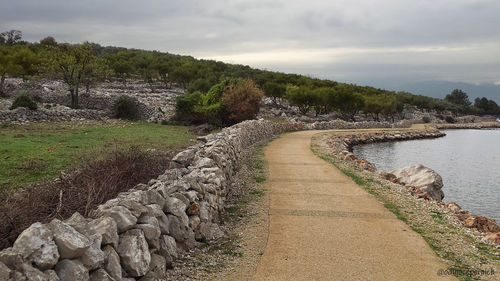 Empty footpath by lake