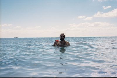 Man drinking cocktail in sea