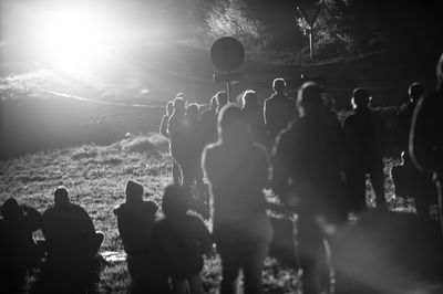 People on field by road