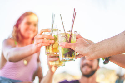 Friends toasting cocktail glasses